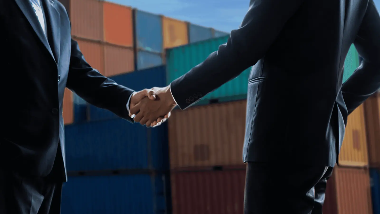 Business partners meeting in front of an international container operation